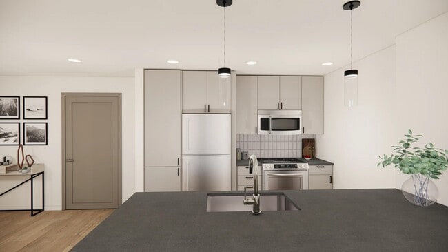 Thoughtfully designed kitchen featuring quartz countertops and stylish pendant lighting. - Modera Bridle Trails