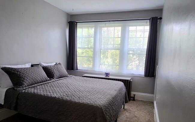 Comfortable primary bedroom featuring a King bed setup and large windows for natural light.
