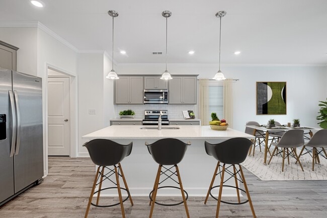 View of the kitchen and entry hallway. Offering bar seating, plenty of cabinet space and granite countertops. - West Oak Trace