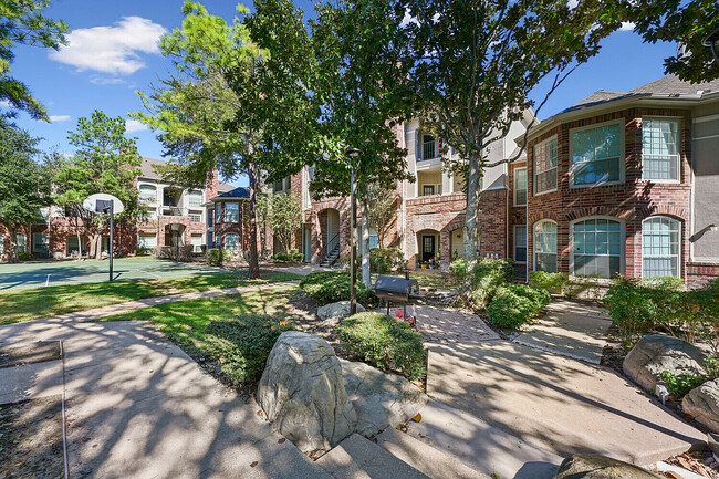 Beautiful Landscaped Walkways - The Henry at Ranchstone Apartments