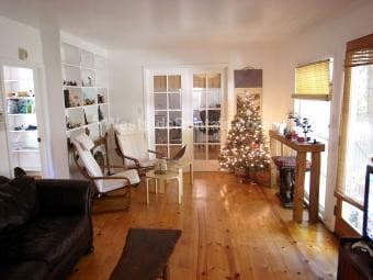 Living room with French doors to bedroom 1 - 3626 Veteran Ave Unit Back House