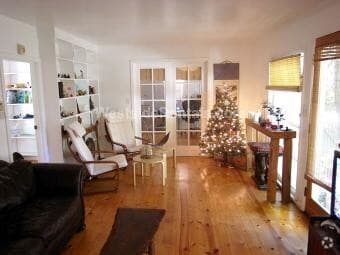 Living room with French doors to bedroom 1 - 3626 Veteran Ave Unit Back House