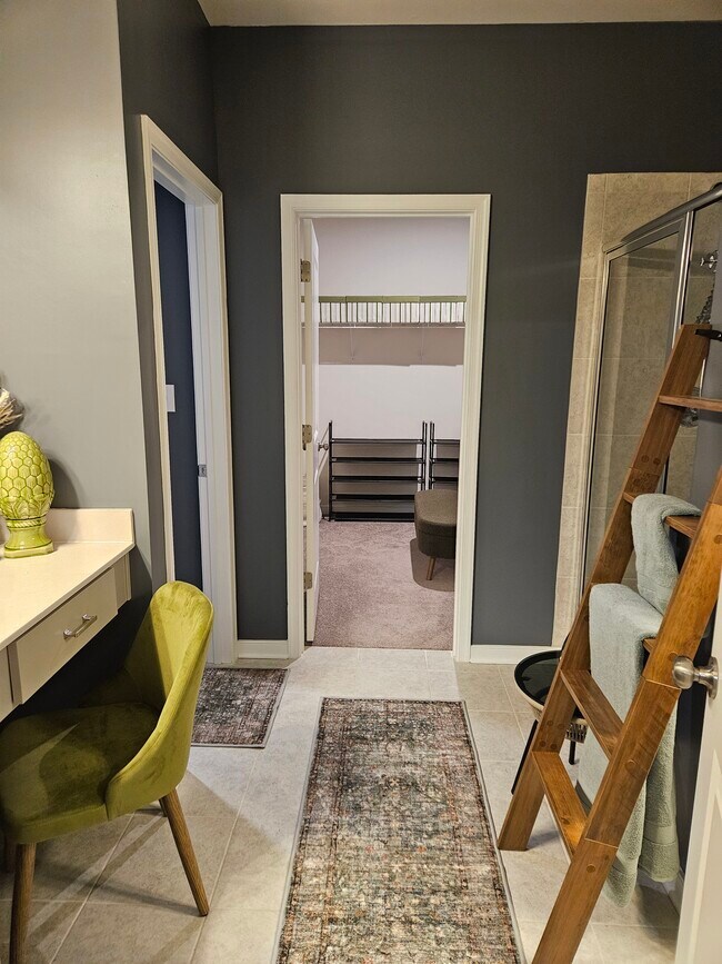 a walk through bathroom leading to the closet and the thrown room - 7201 Hancock Chase Ct Unit Green