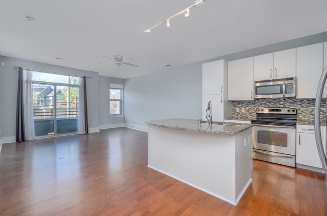 From the dining area looking at the living room, balcony, and kitchen - 1600 Fulton Ave Unit Fulton202