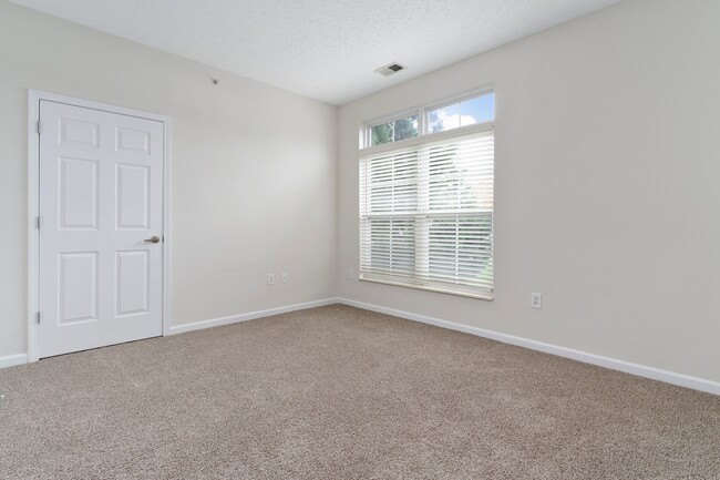 The Charleston Magnolia Premium Renovated Bedroom offering abundant natural light through transom windows