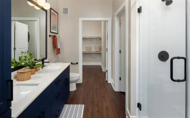 A spacious closet opens off the bathroom, and two sinks keep mornings easy.