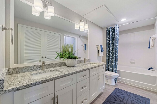 Upgraded Apartments - Contemporary bathrooms with framed mirrors - Reserve At Beachline Apartments