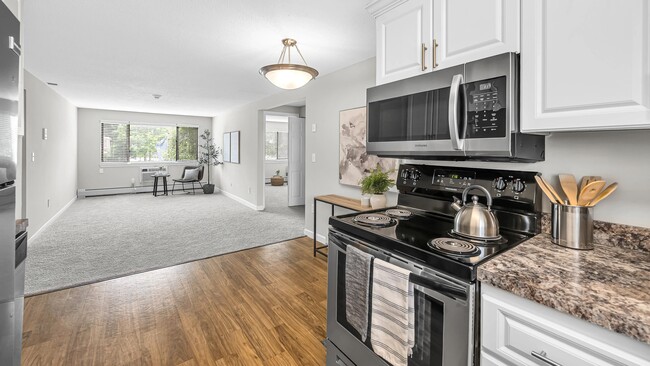Experience dining joy in our contemporary kitchens, complete with modern, white cabinetry, stainless steel appliances and sleek wood-style flooring.