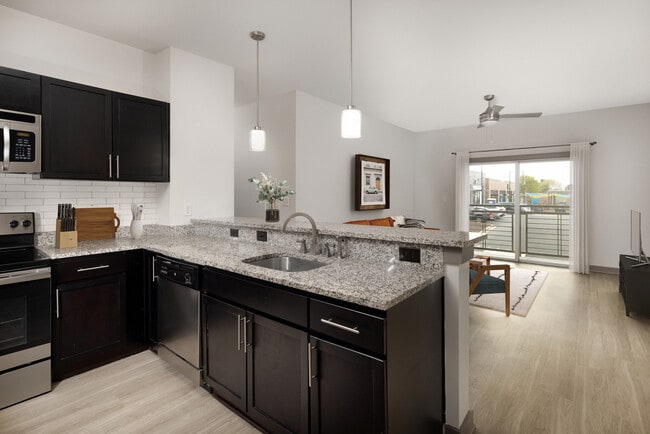 Renovated Package II Kitchen, living and dining area with hard surface flooring throughout and pendant lighting