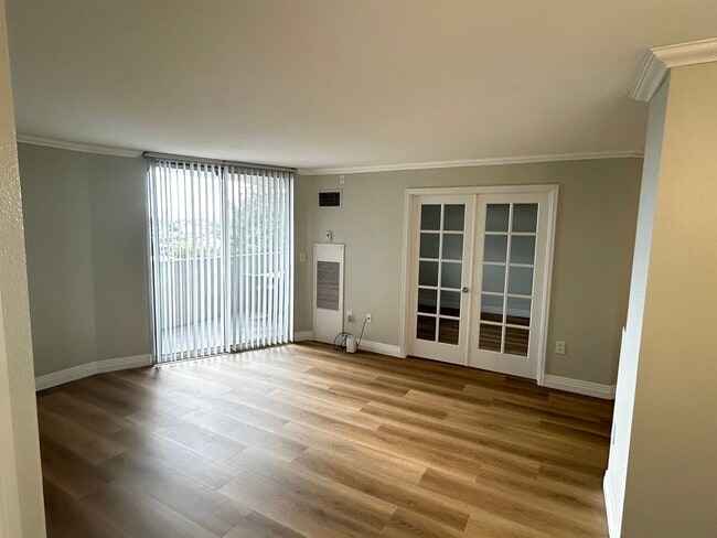 Living Area with french doors to second bedroom - 601 W 11th Ave Unit 517