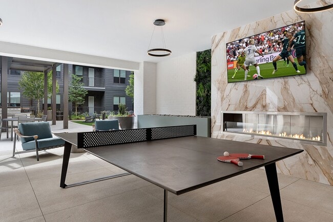 Outdoor passthrough with ping-pong, wall Scrabble, TVs and ample seating