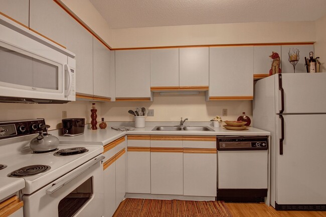 Town Centre Kitchen View with Oven, Microwave, and Fridge - Town Centre Apartments