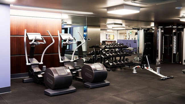Expansive fitness center with elliptical, free weights, and weight stations