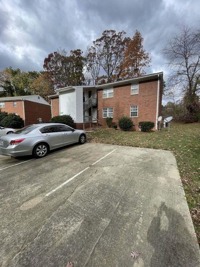 Brick building with paved parking - 104 Hunters Ct Apartments Unit 104A