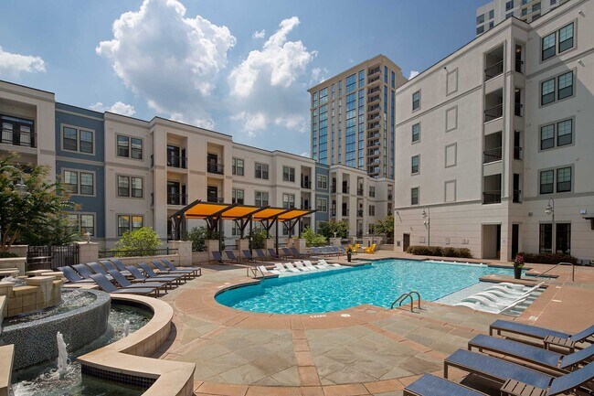 Pool with in-water and dry lounge seats, fountain and covered seating
