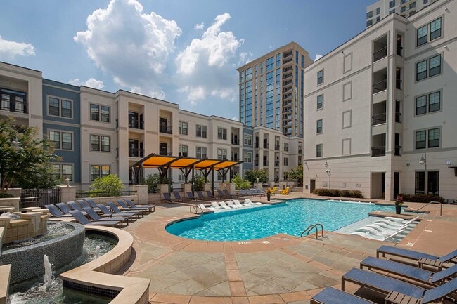 Pool with in-water and dry lounge seats, fountain and covered seating - Elle of Buckhead