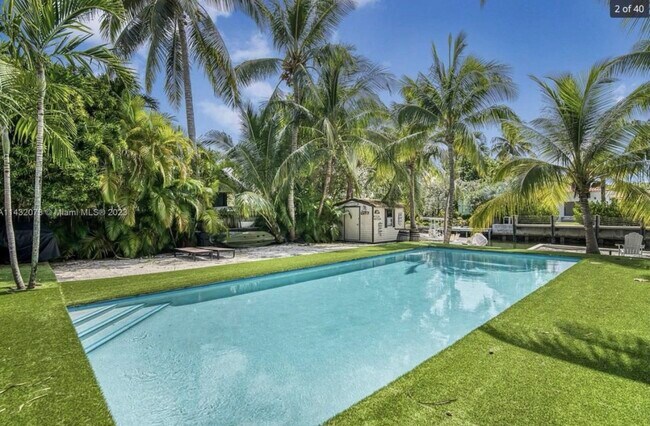 Tropical garden with canal front view - 7960 Hawthorne Ave