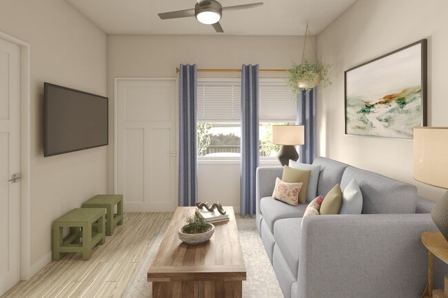 Greenwood Commons living area showing the front door and window to the balcony/patio. - Greenwood Commons Apartments