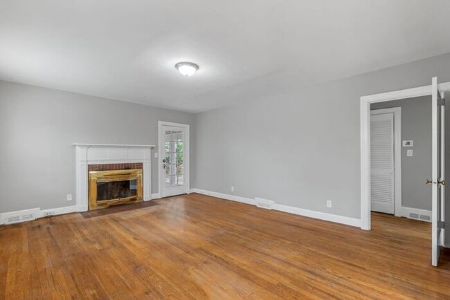 Photo - Brick home, Two Story, Hardwoods, DR, 2 Sun Rooms, FP, Carport!.