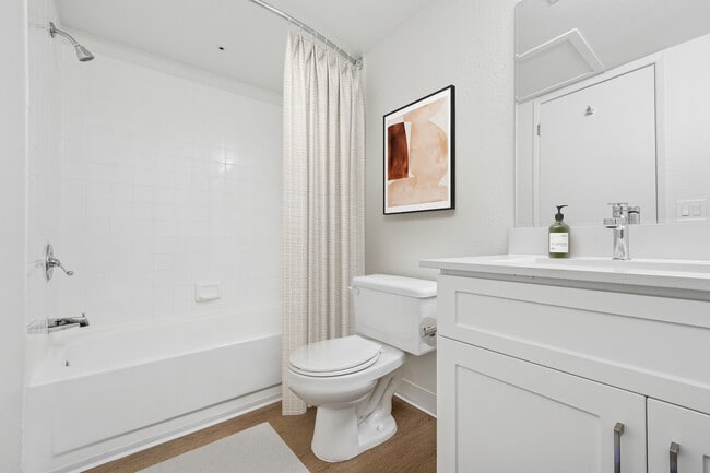 Upgraded Collection bath with white cabinetry, quartz countertop, and hard surface flooring - eaves Walnut Creek
