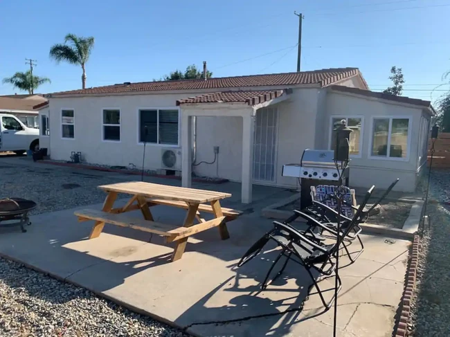 Outside Patio, Fire pit with BBQ with the home in the background. - 12964 Roswell Ave Casa