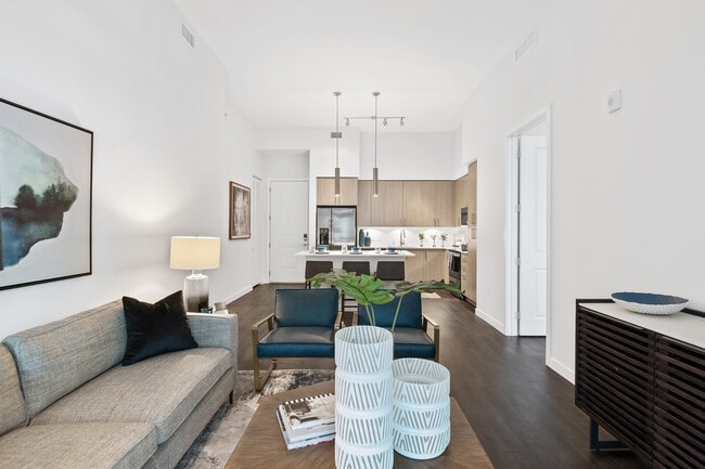 Kitchen, living, and dining areas with hard-surface vinyl plank flooring