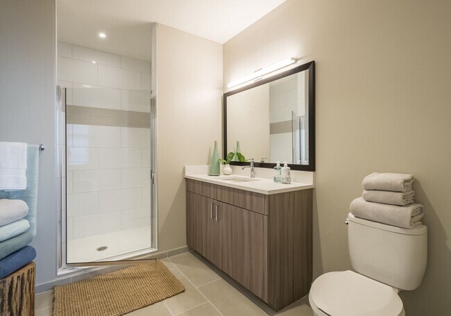 Modern bathrooms with walk-in showers and stylish finishes at Spectra at Sibley Square.