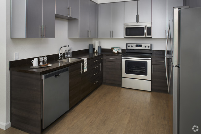 A selection of interior finishes available with luxury faux wood flooring & stainless steel appliances - LINQ Rental