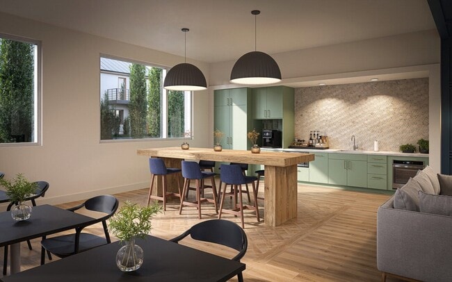 Community kitchen and coffee bar with modern seating and natural light.