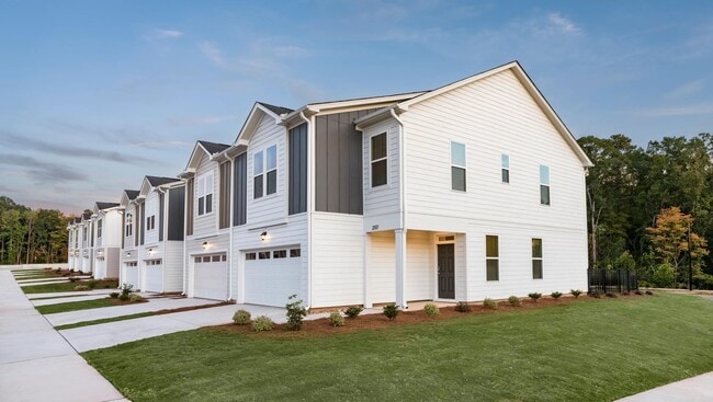 Modern townhome exteriors at Amavi Brier Creek, offering refined living in Durham with convenient access to Brier Creek’s shopping, dining, and commuter routes.