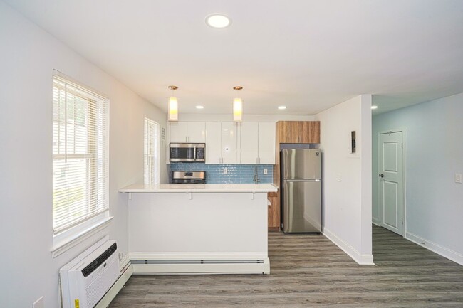 Living room and kitchen at Drumcastle Apartments in Baltimore, MD
