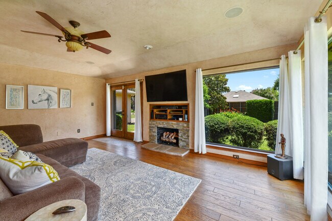 Open living room with large 65" TV - 7300 Augusta Cir