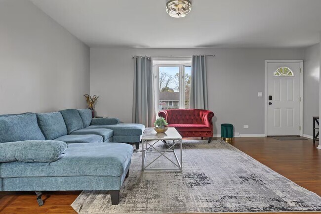 Sala de estar con sofá cama, televisor inteligente y armario. - 1002 Juniper Ln