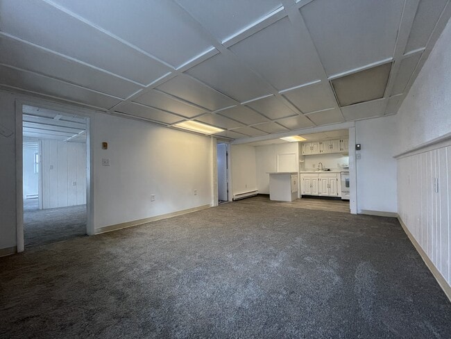 Living room with view of bathroom door - 139 S York Rd Unit 3