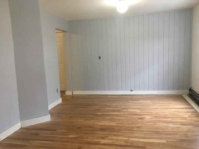 Living room view from bottom of stairs (looking at entrance) with recently finished red birch flooring. Spacious! - 12 Boynton Street Unit Apt 3