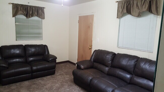 Leather reclining loveseat and couch with skylight. - 1216 University Ave Apartments Unit #3