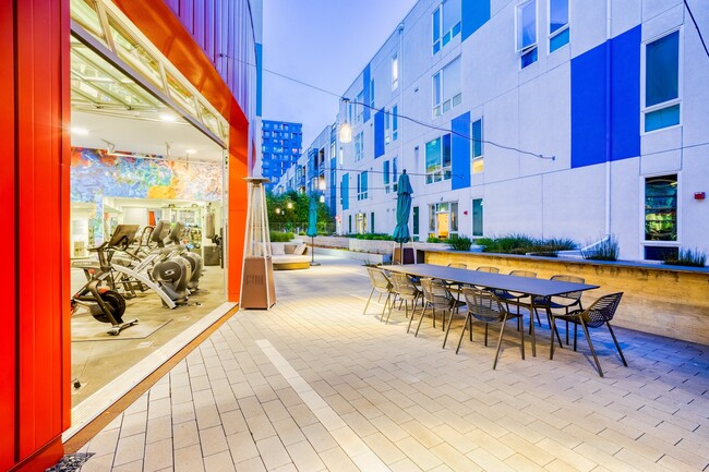 The fitness center garage doors open up to the courtyard for fresh air - Mission Bay by Windsor Apartments