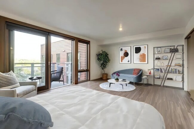 One room handles sleeping and sitting, with the balcony adding a third space.