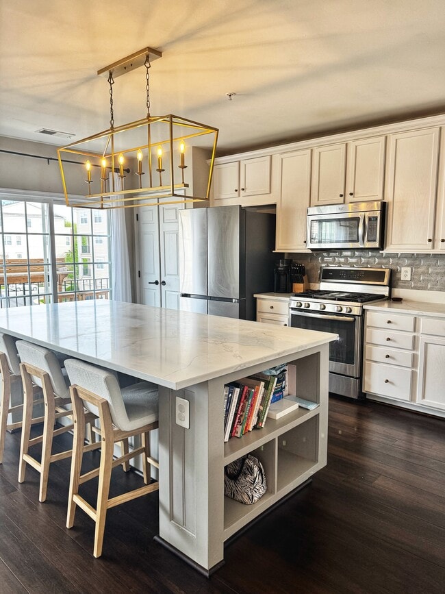 Large kitchen island with 3 barstools, suitable for hosting, casual dinners, and conversation - 22795 Settlers Trail Ter