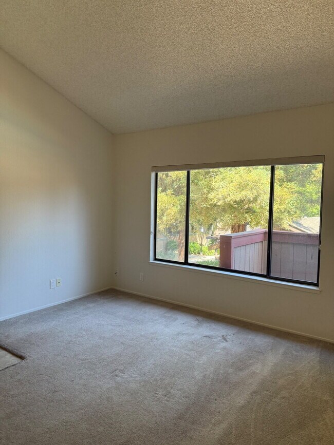 Photo - Spacious 3-Bedroom, 2-Bath Multi-Level Home with Balcony, In-Unit Laundry & Dual Parking