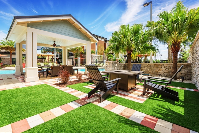 Outdoor fireplace with seating - Nona Park Village Apartments