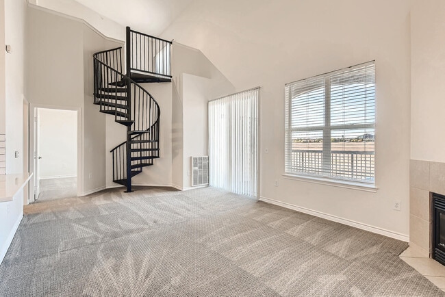 A Living Room with a Spiral Staircase at Fox Run Lofts