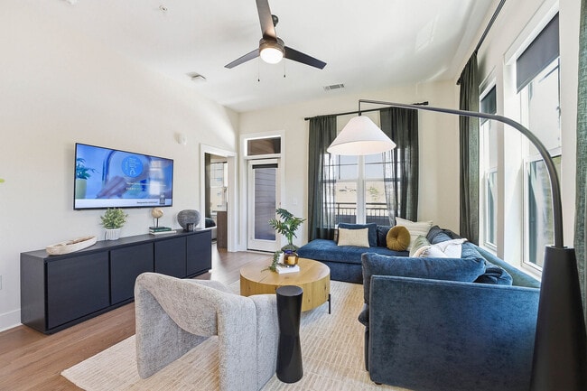 Spacious living rooms with solar shades - AMLI Brookhaven