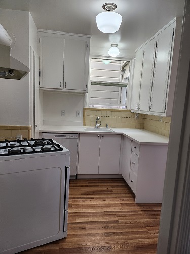 Kitchen with retro gas stove, dishwasher and refrigerator and - 93 Stanyan St Apartments Unit 93StanyanStreet