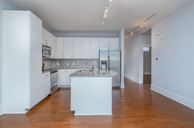 Kitchen and dining area, with a look at the 2nd bedroom entrance on the right - 1600 Fulton Ave Unit Fulton202