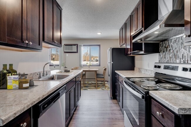Elevate your living at St. Anthony Group with this modern kitchen featuring sleek cabinetry and stainless steel appliances. Enjoy spacious layouts and convenient amenities ideal for your lifestyle. Schedule your tour today and see for yourself!