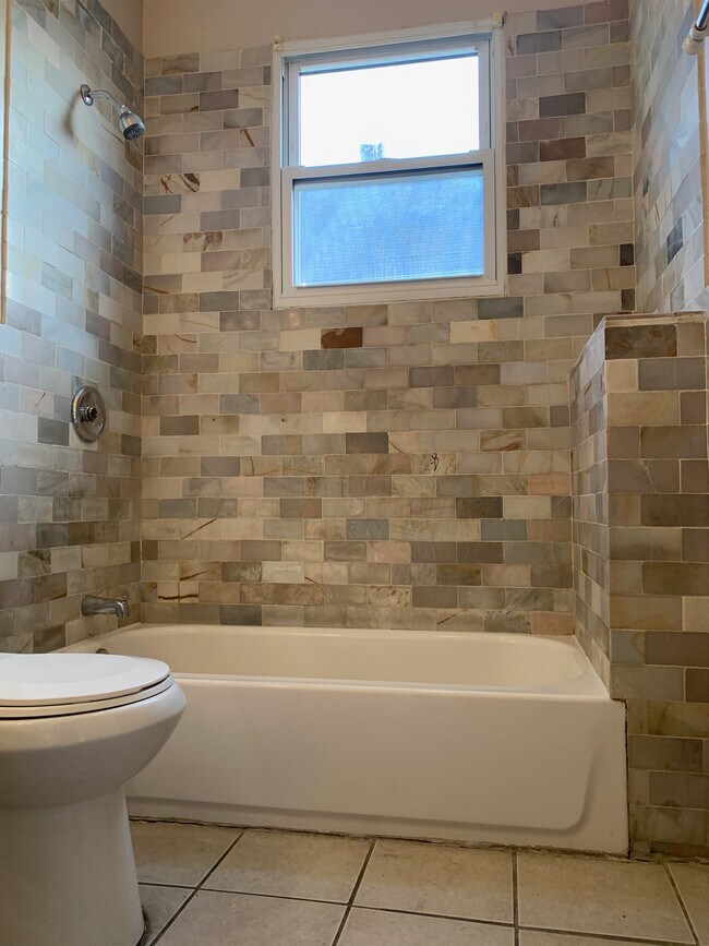 Textured mosaic tiles in common bath - 69 Schley St Unit 1