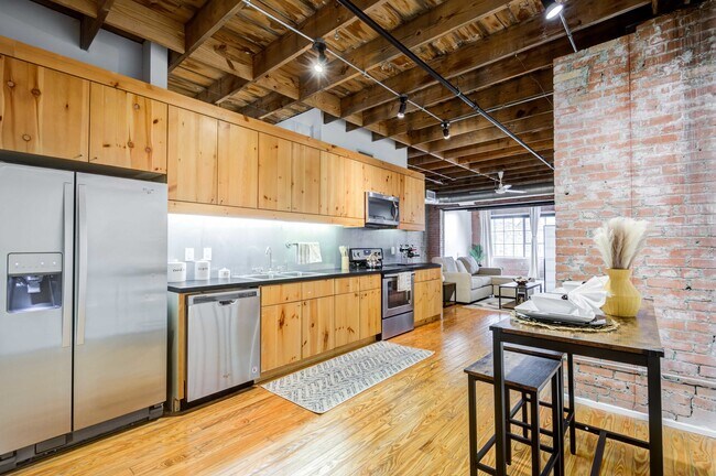 Renovated Lofts with exposed steel beams and brick accents