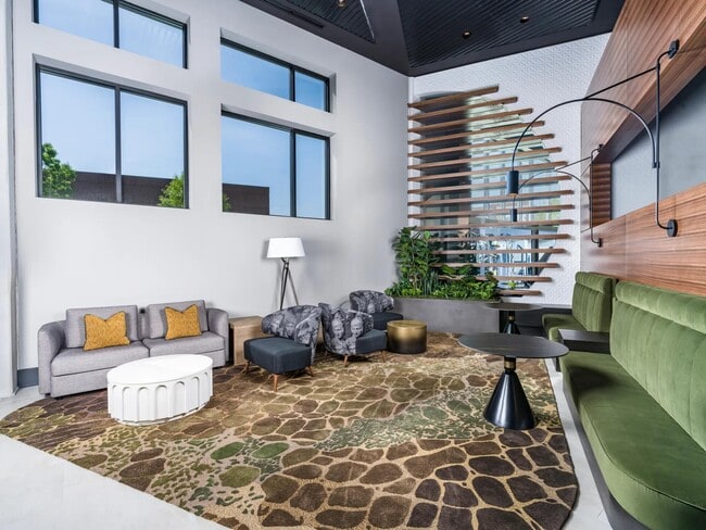 This lobby lounge offers bold design and inviting comfort, perfect for catching up, winding down, or simply enjoying the space. - Modera H Street