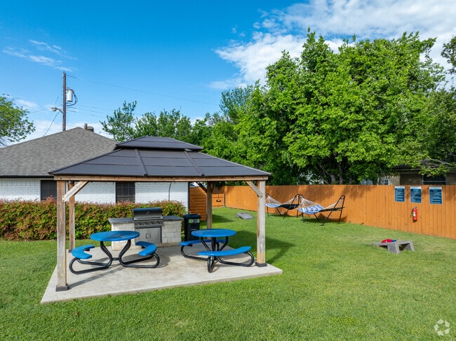 Grilling Area with Hammocks & Cornhole - Eleven06 on 35 Apartments